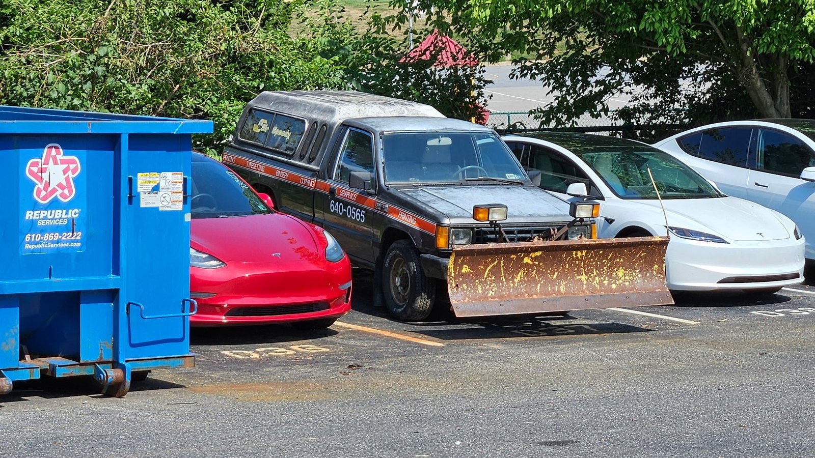 1988 Dodge D50 4x4 with rusted snow plow blade and bed cap, parked after delivery